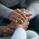 woman's hands holding another set of hands, consolingly