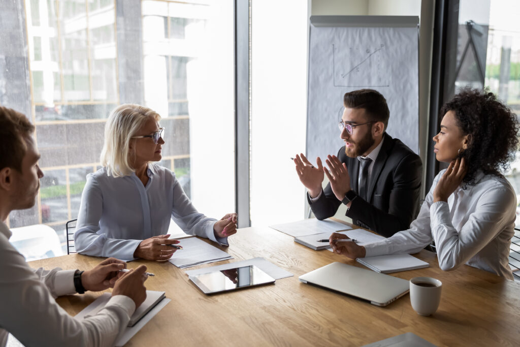 A couple negotiating divorce with their respective attorneys