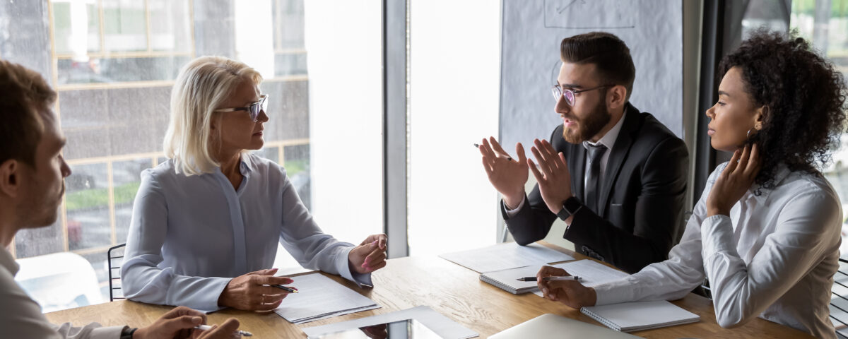 A couple negotiating divorce with their respective attorneys