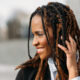 Smiling young Black woman with braids.