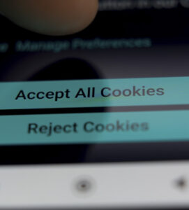 Finger on a screen accepting or rejecting website cookie statement
